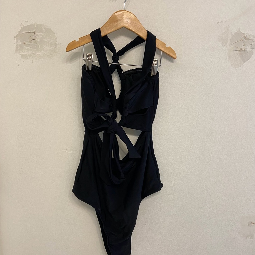 Amazon Woman’s Black One-Piece Swimsuit with Tie-Back
